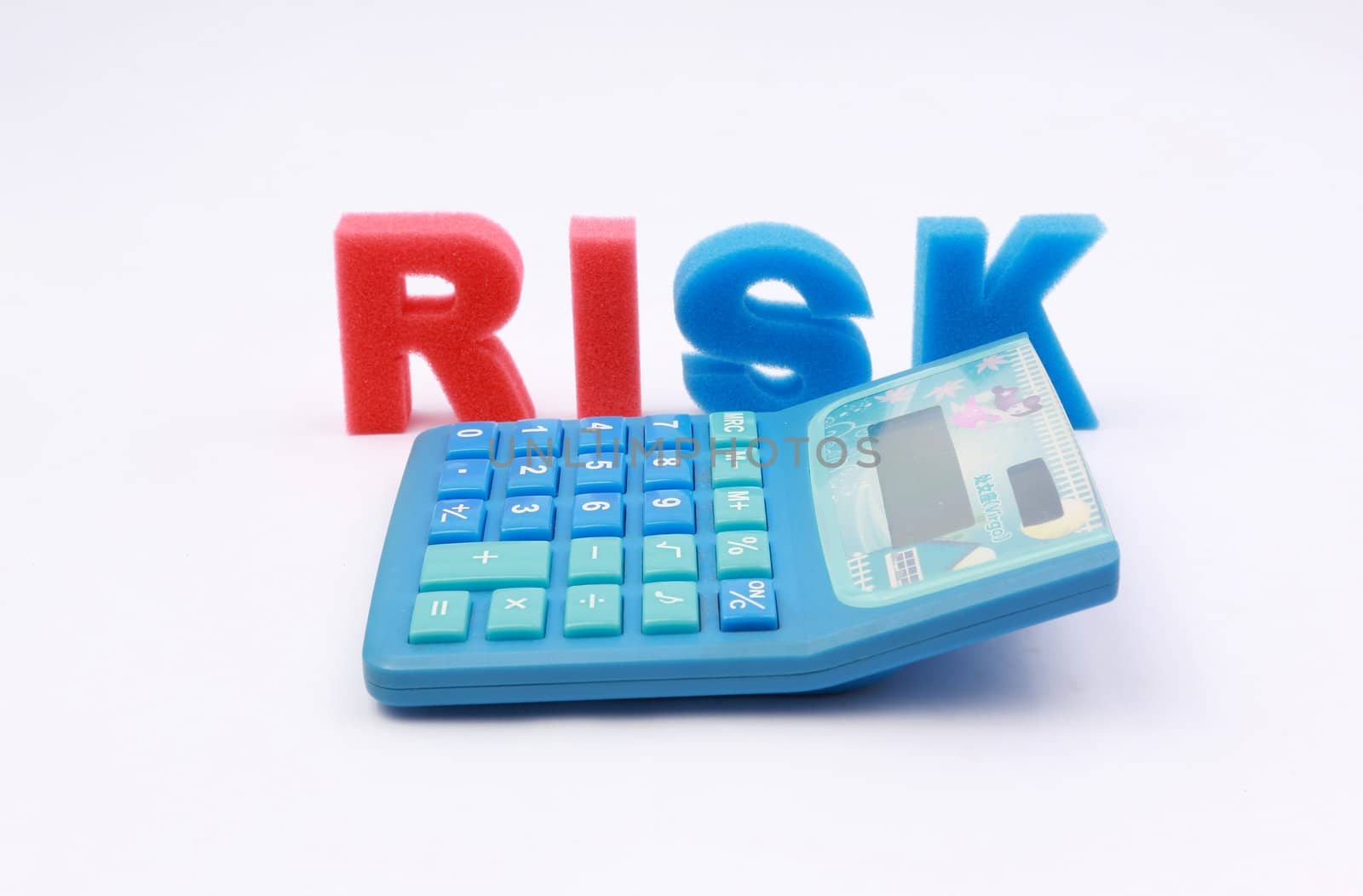 Risk word spelled out with calculator as foreground