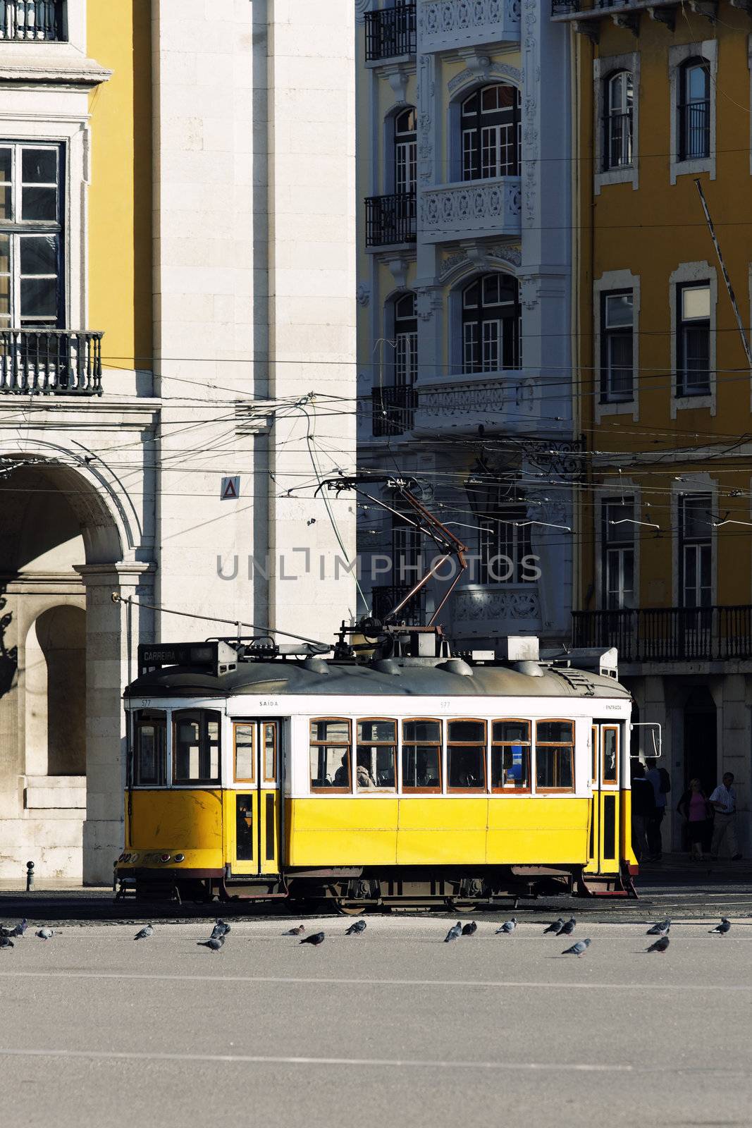 Typical yellow Tram in old street, Lisbon