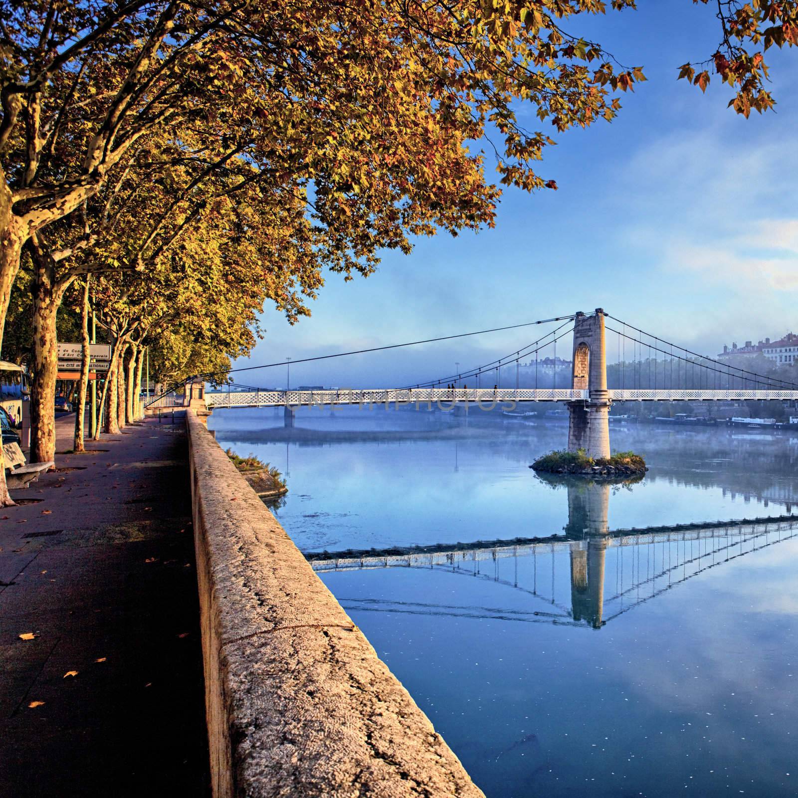 sunset on footbridge in Lyon city in autumn