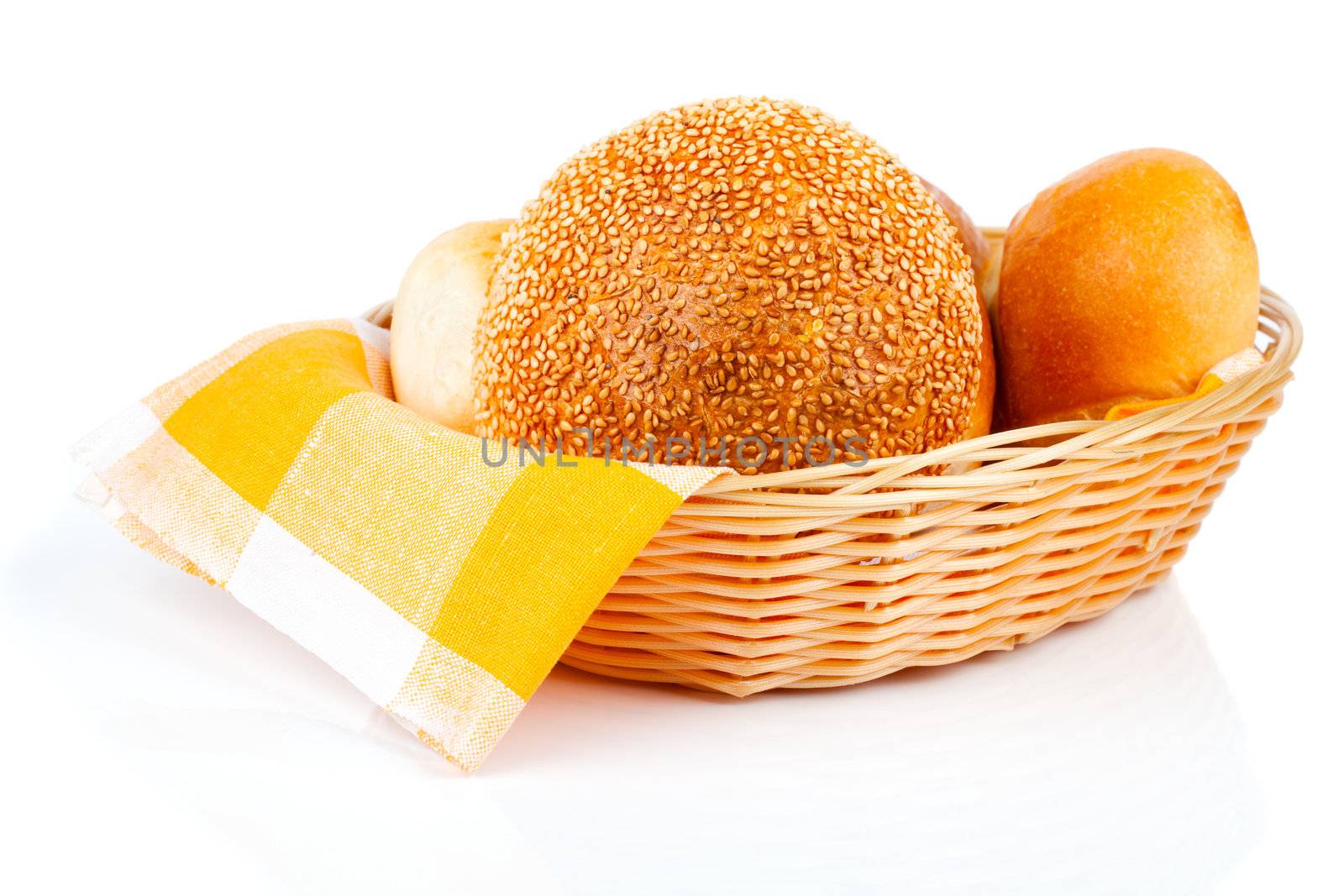 fresh baked buns in a basket on white background