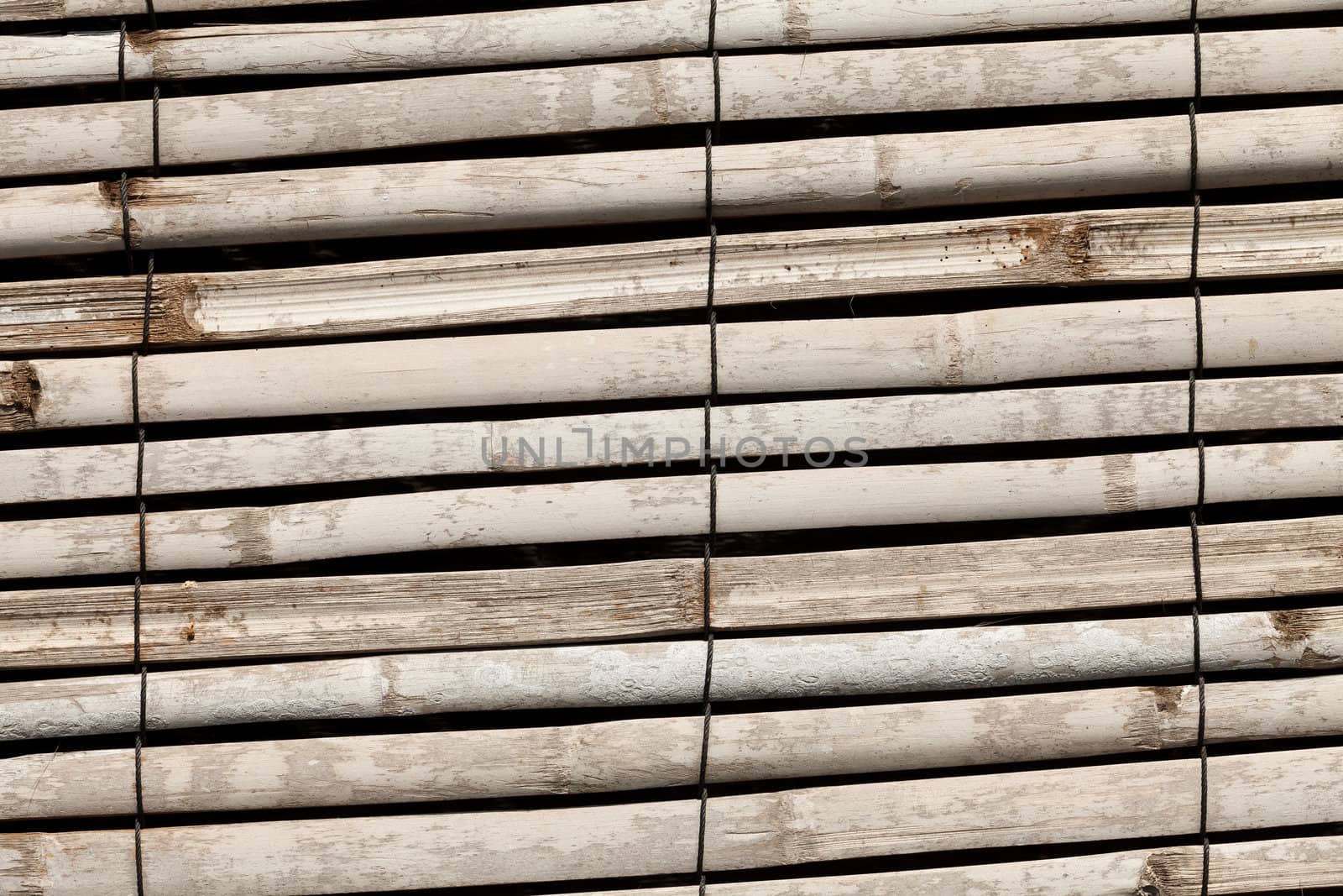 Wall from the tied up wooden planks