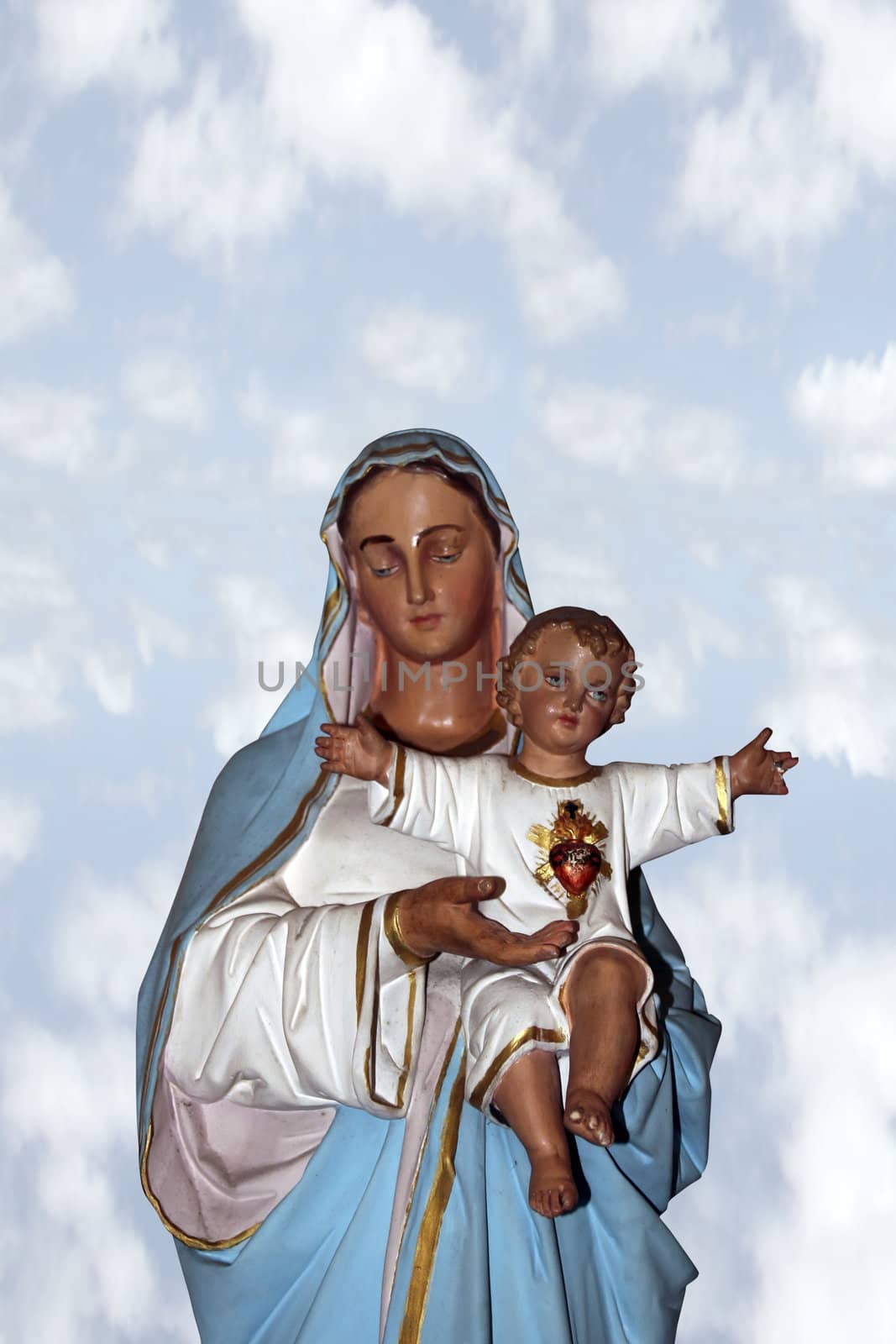 statue of the virgin mary holding jesus christ as a baby with a clipping path