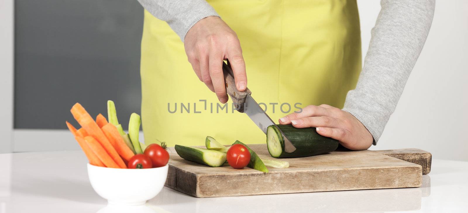 Woman cutting vegetables in kitchen