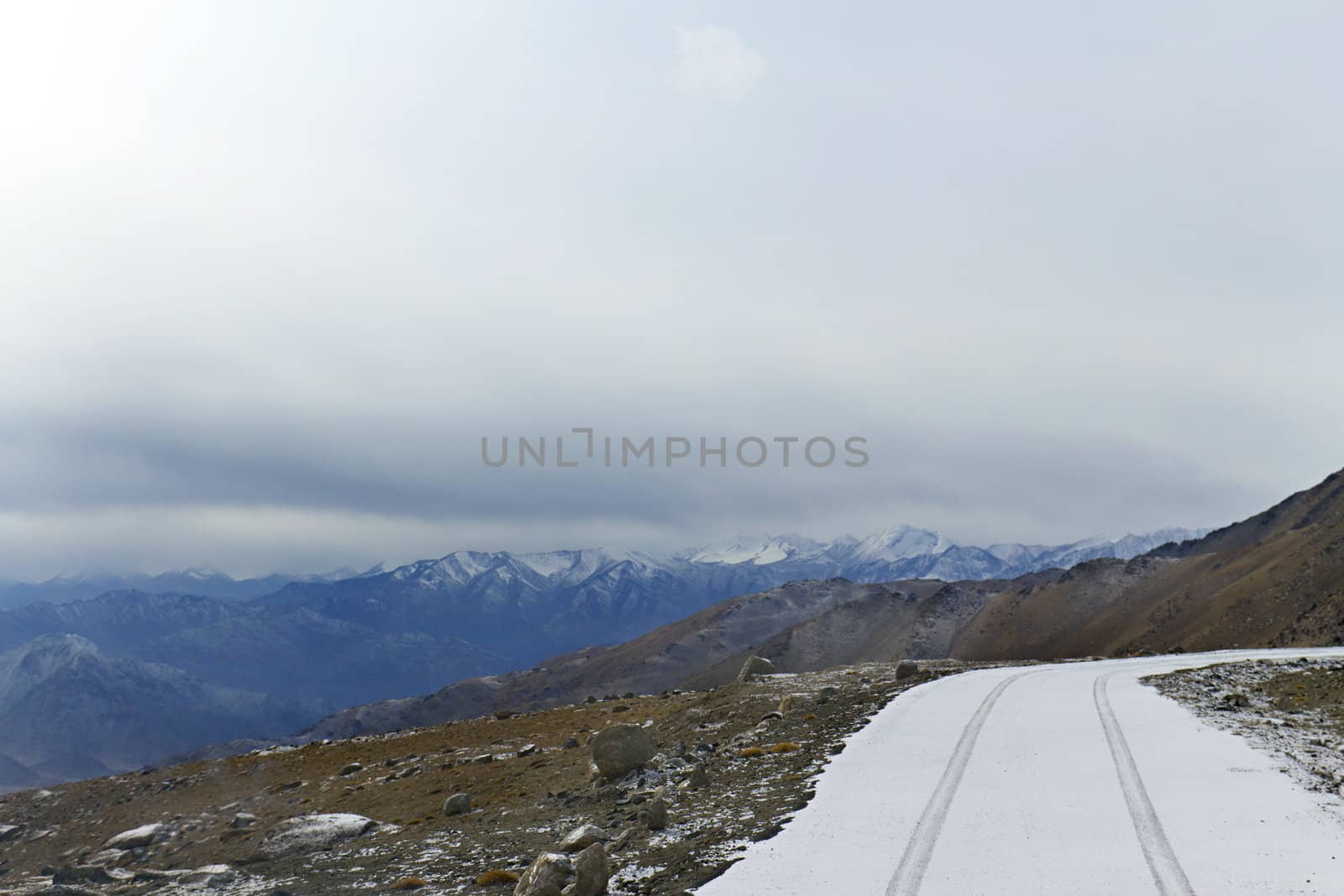 Snow-covered road on a mountain pass by Plus69