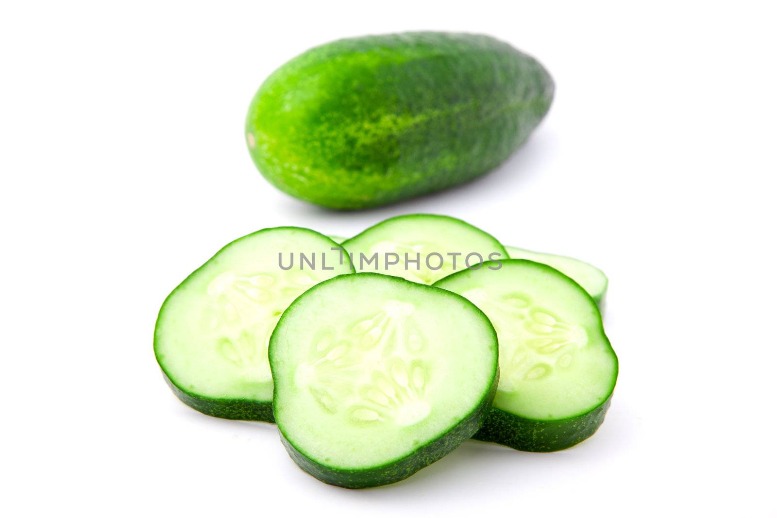 Cucumber and slices isolated over white background.