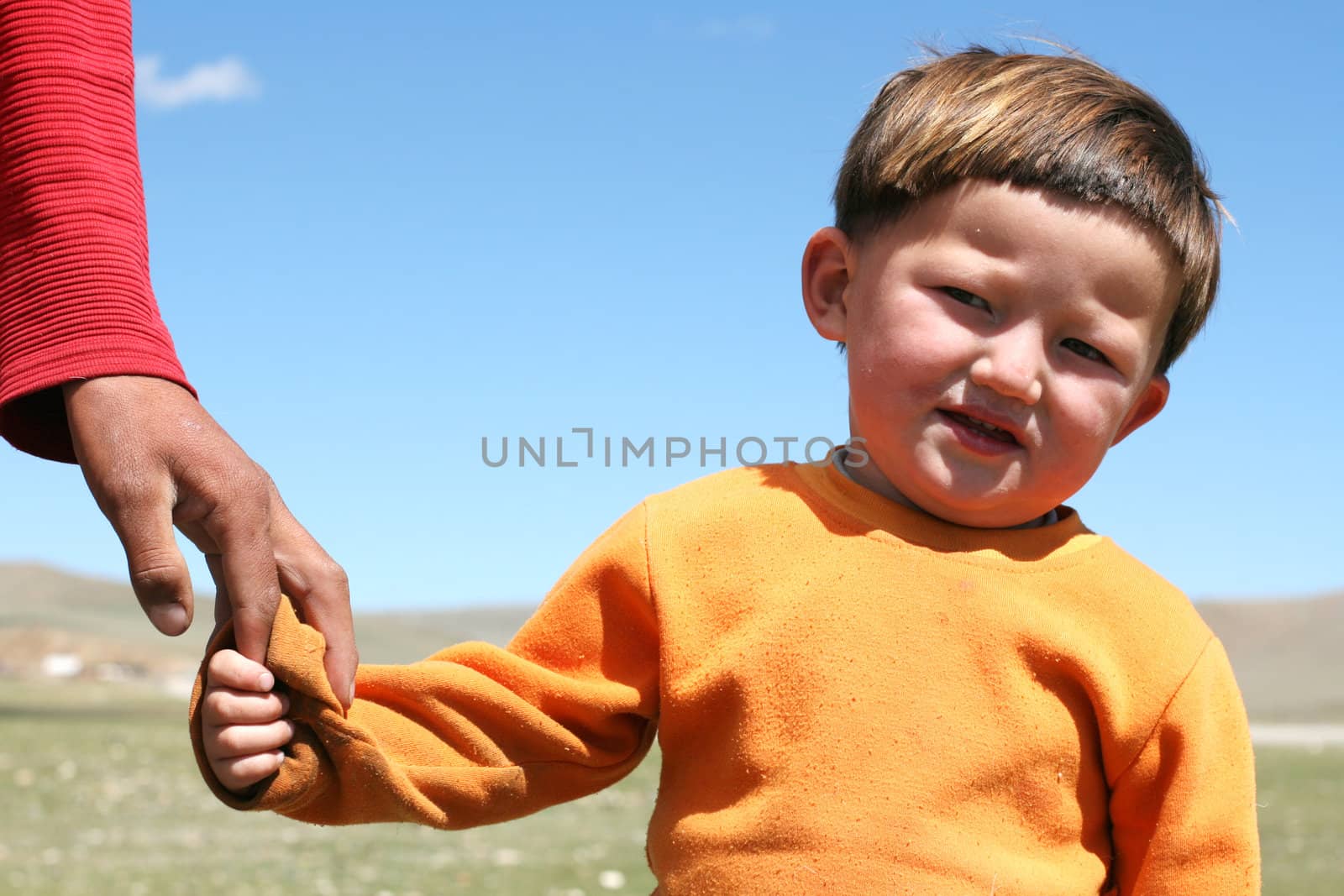MONGOLIA, AUGUST 06, 2008 - mongolian boy keeping fathers by arm