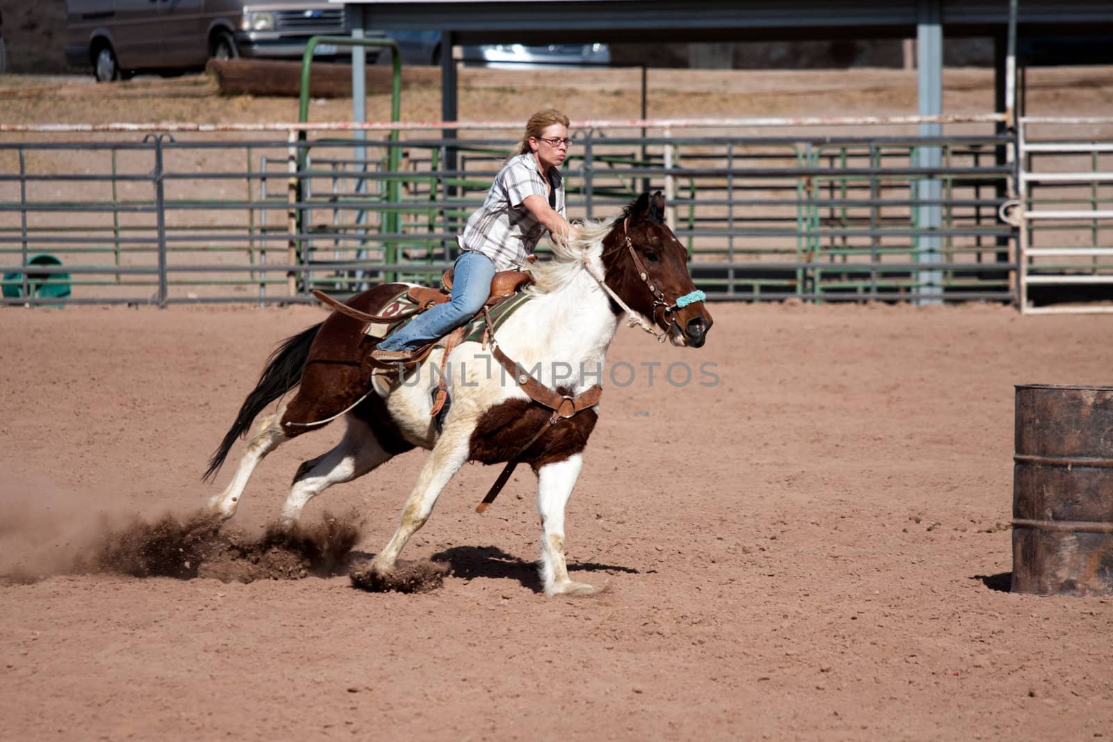 Women horse barrel race in corral in las vegas