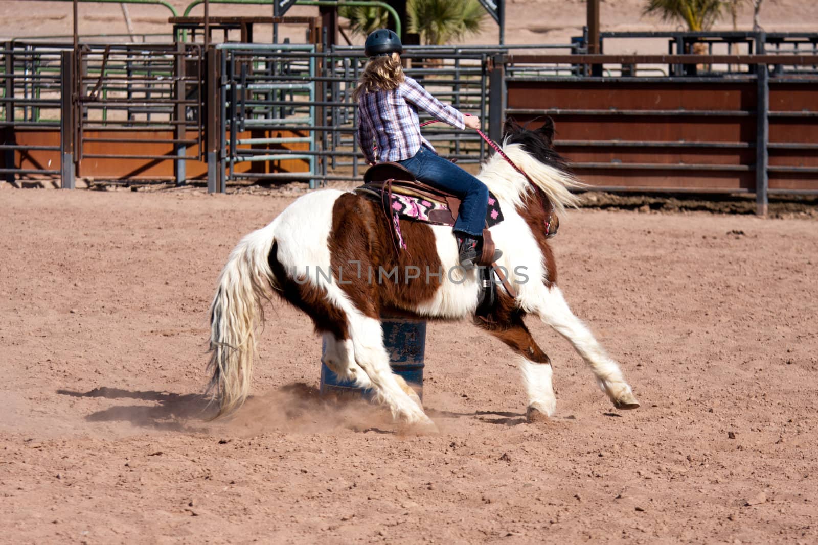 Women horse barrel race in corral in las vegas