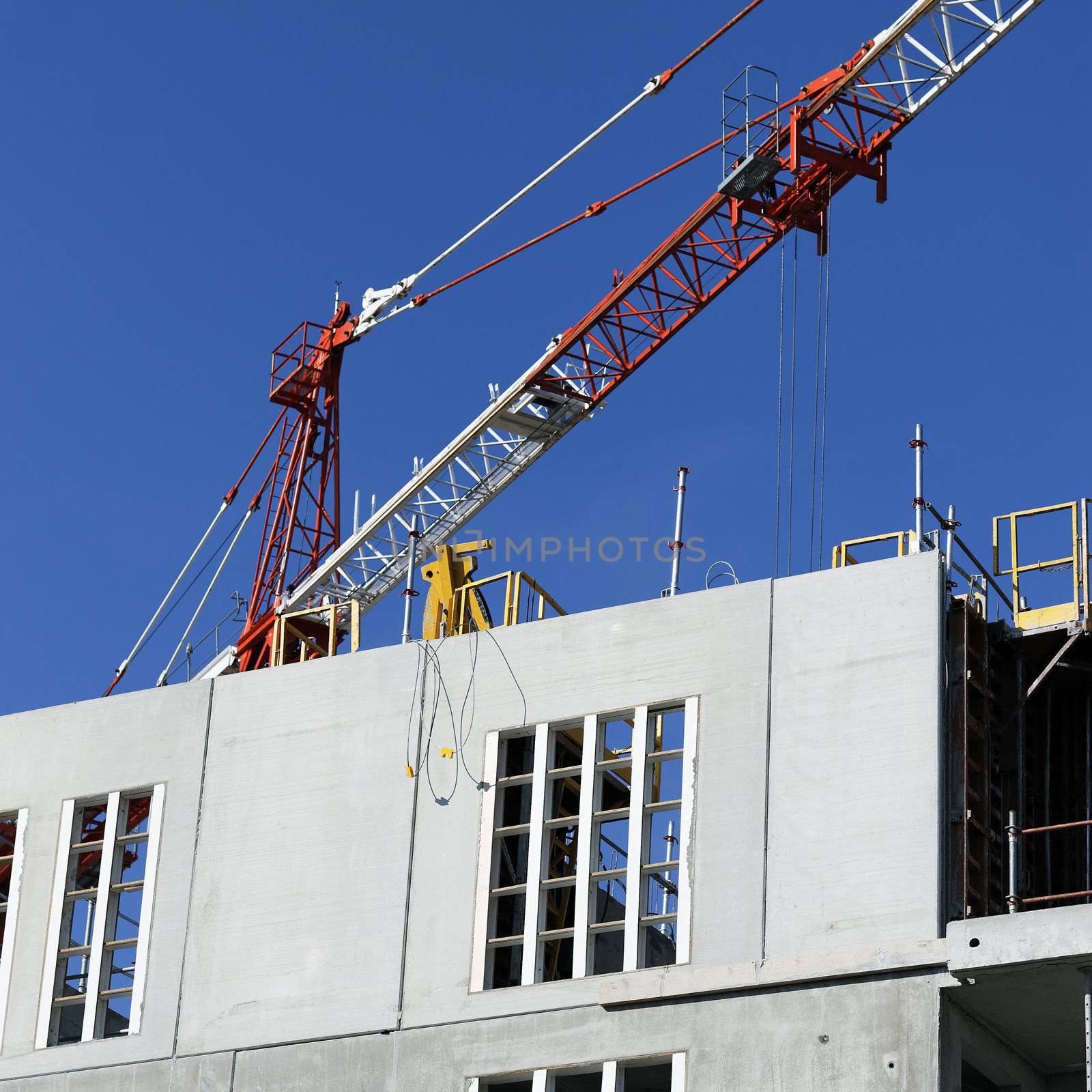 Construction site with crane in blue sky in summer