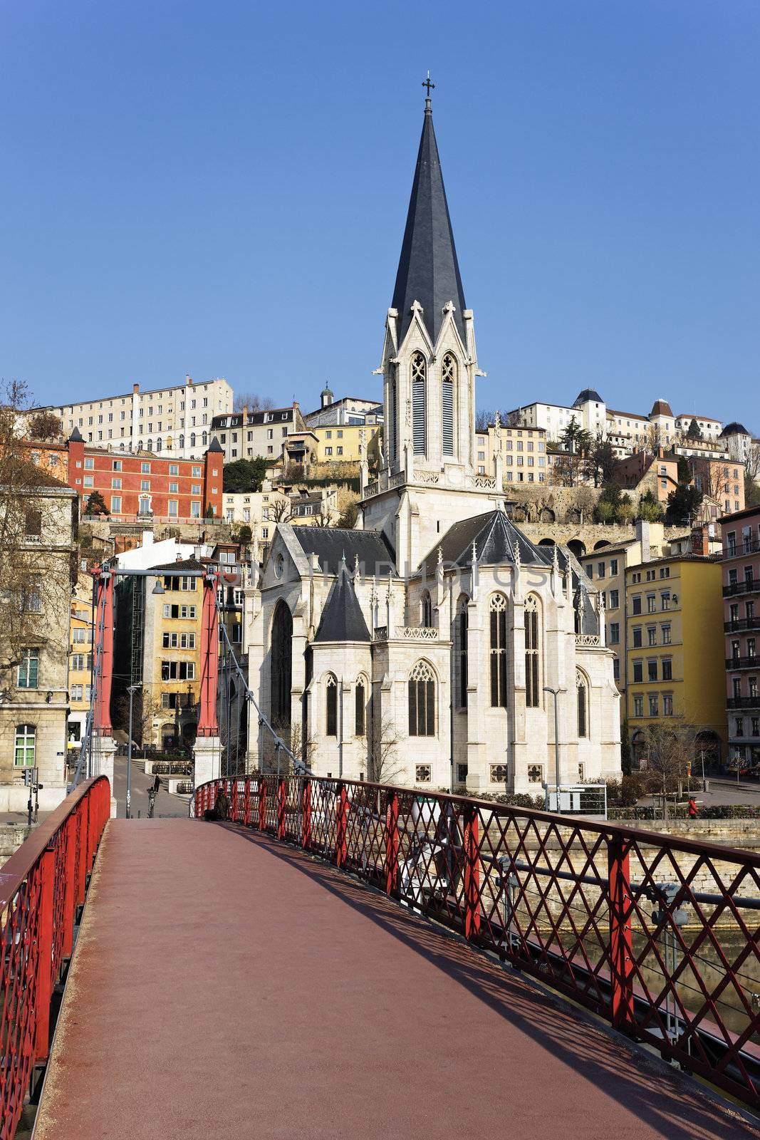 Lyon with famous red footbridge on Saone river and church 