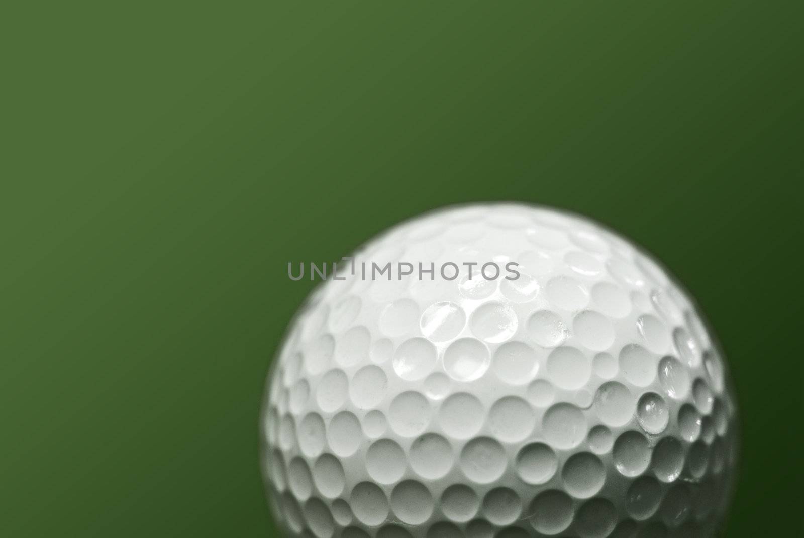 Golf ball on green background