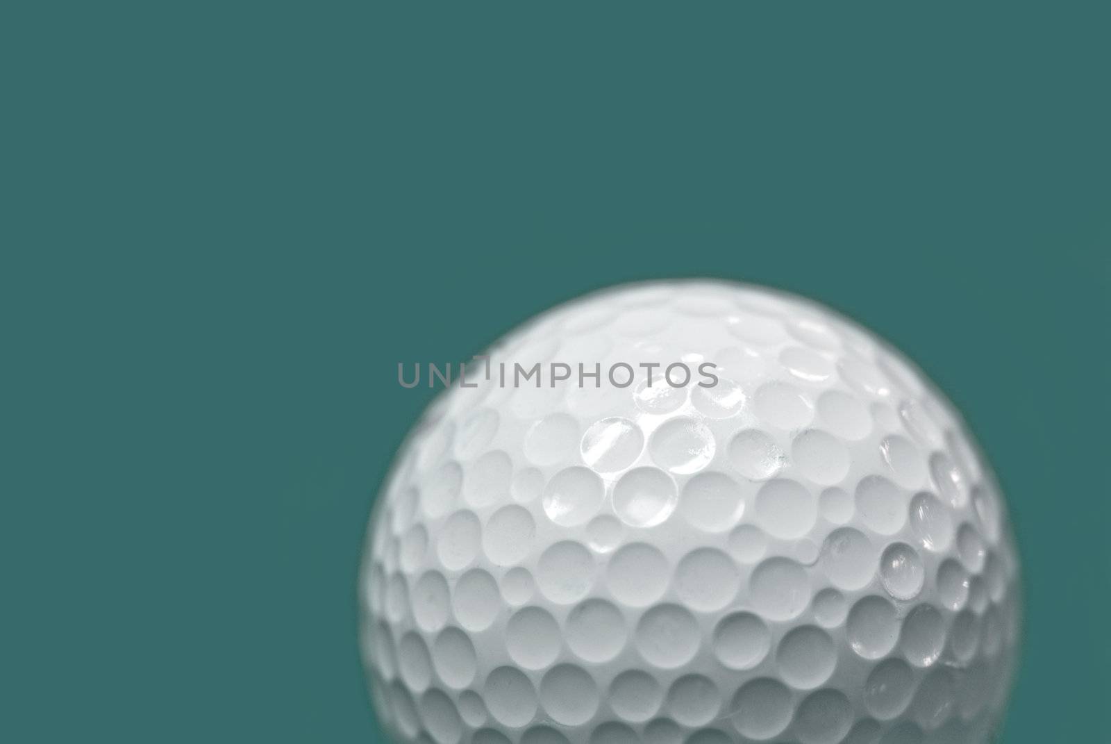 Golf ball on green background