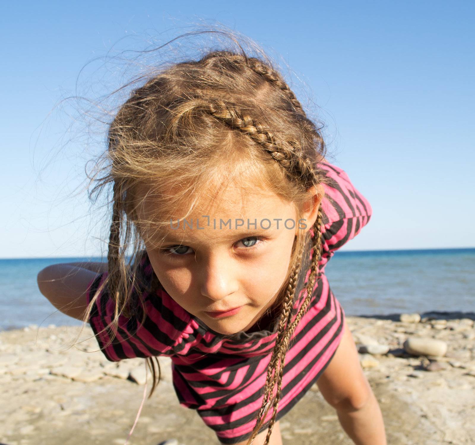 funny little girl on sea background