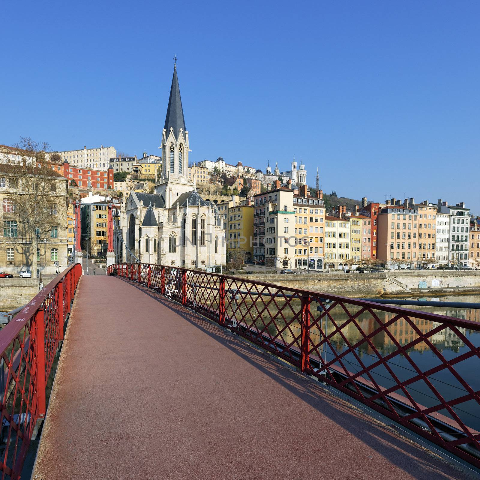 Lyon with famous red footbridge and church 