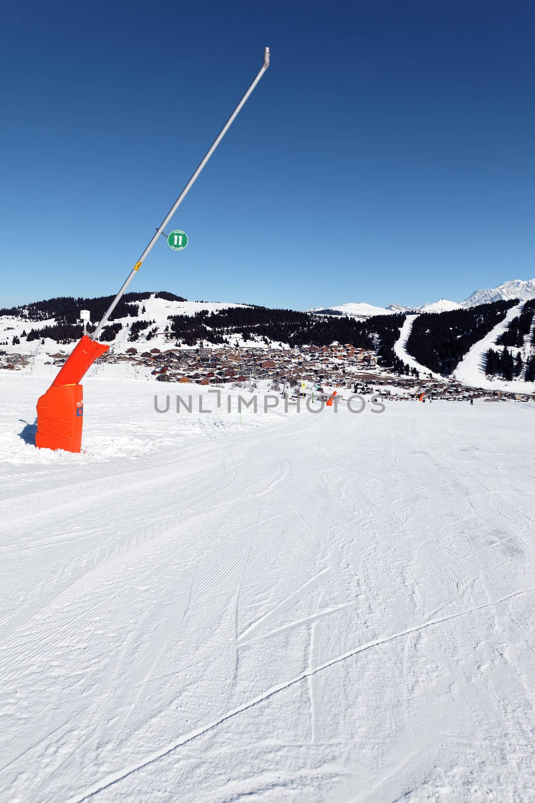 snowmaker on ski track in french alps