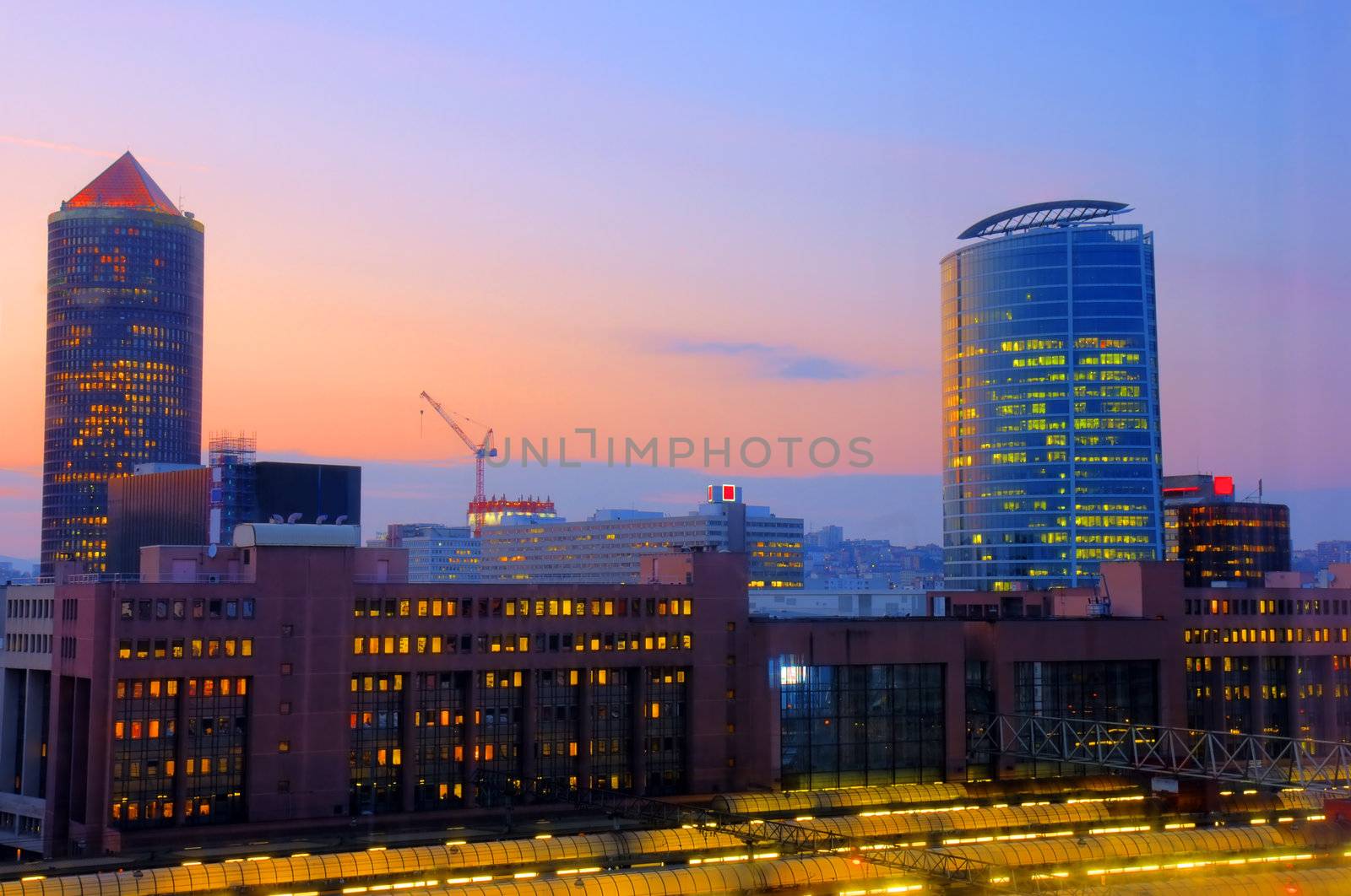 Beautiful lights of a sunset over a modern area of an old city with train TGV station in the foreground, Lyon, France.