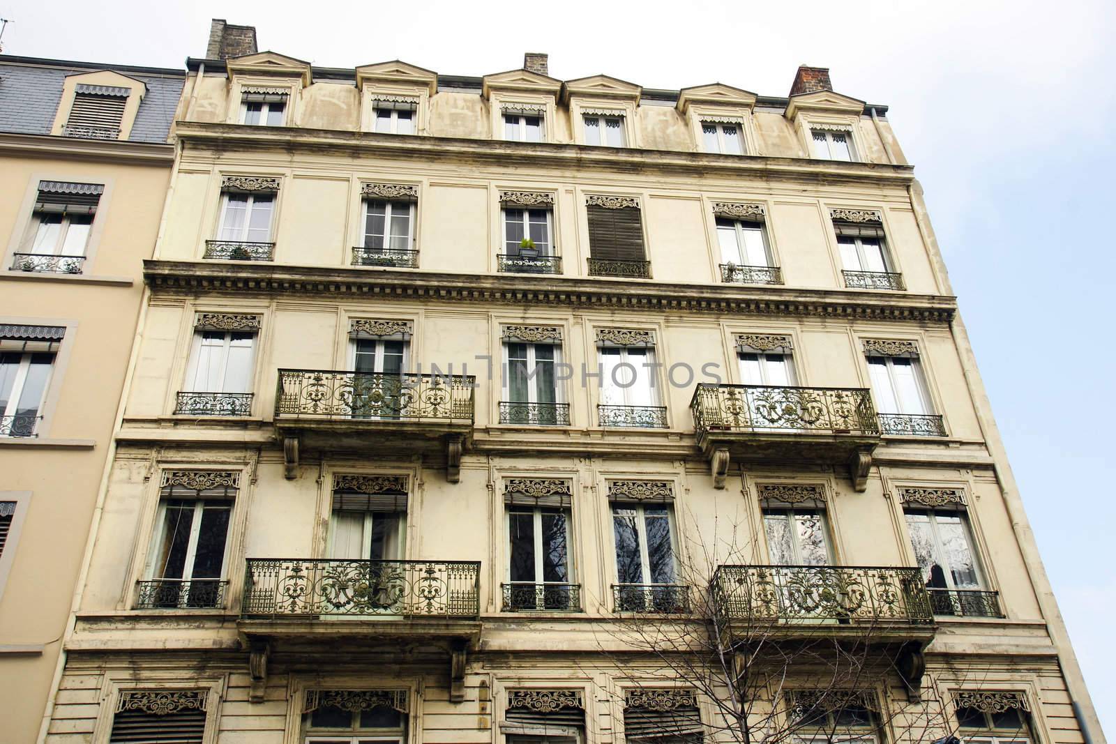 Architecture :Old building apartments or flats in a European city with beautifuly crafted wrought iron balconies.