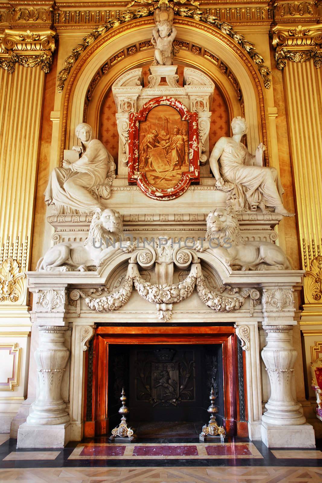 Magnificent marble fireplace with people and lions in european building, hotel de ville in Lyon France, rococo style.