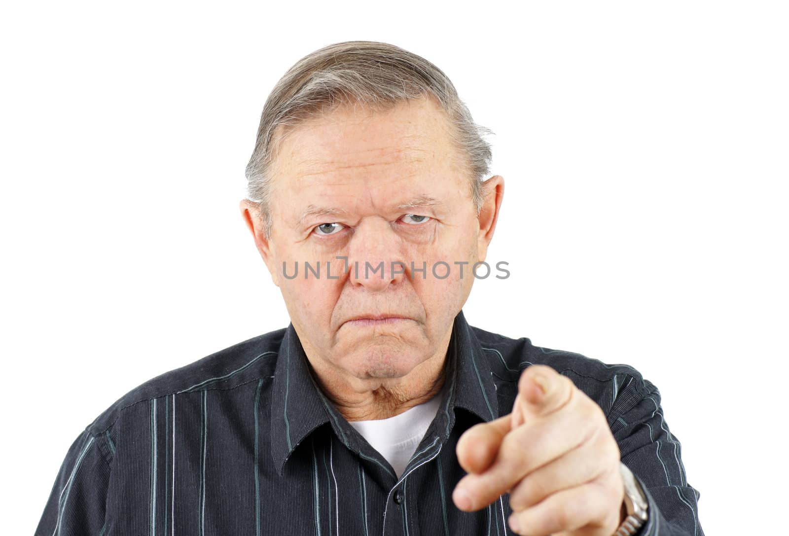 Grumpy angry senior or old man pointing his finger at the camera with a big frown on his face, blaming or warning you.