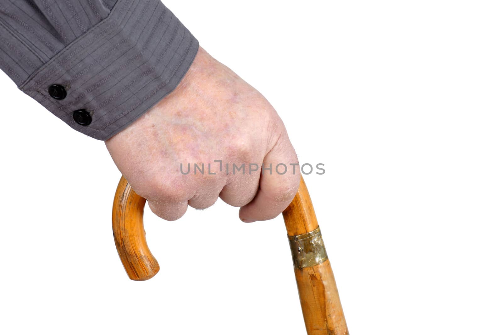 Senior man's hand hording an old wood cane to support himself as he walks, great details.