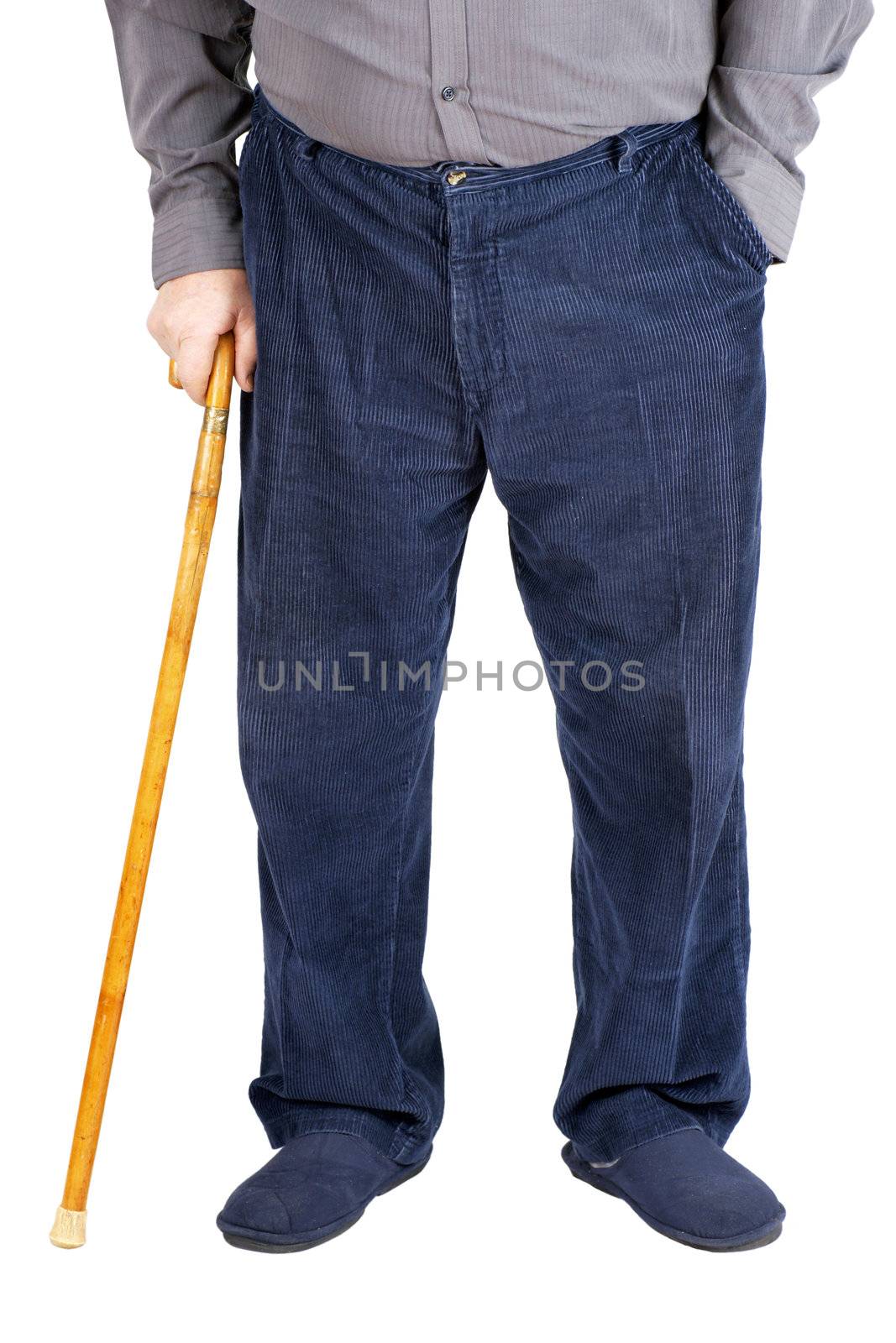 Bottom half of an old man or elderly person walking with a wood cane, wearing and blue corduroy and slippers, isolated on white.