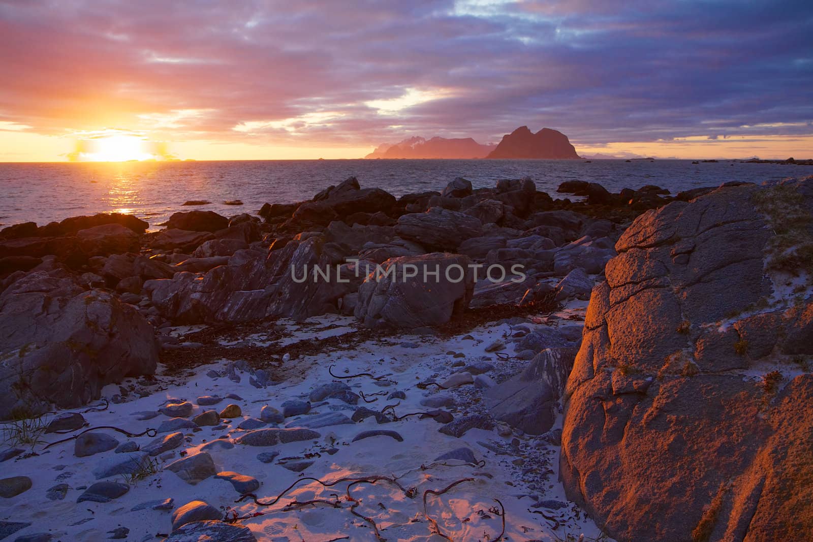 Scenic view of midnight sun on the beach of Lofoten islands in Norway