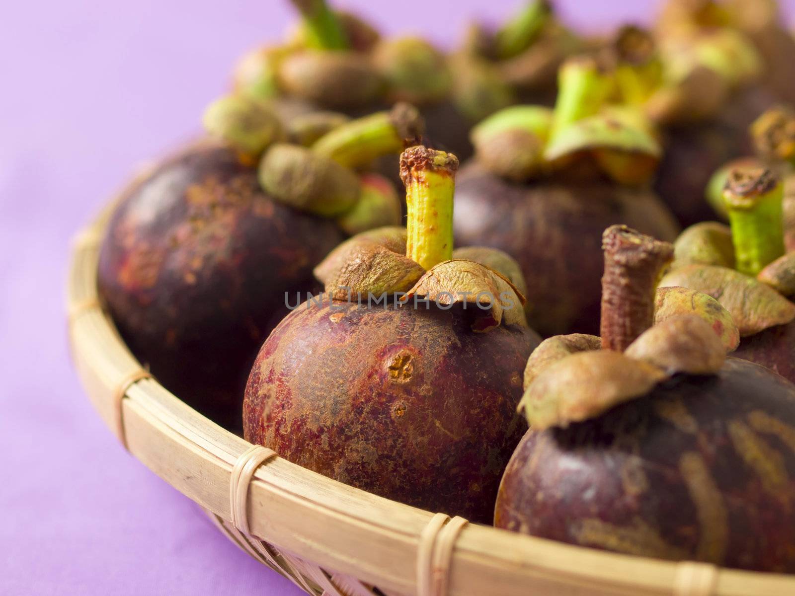 close up of a basket of mangosteens