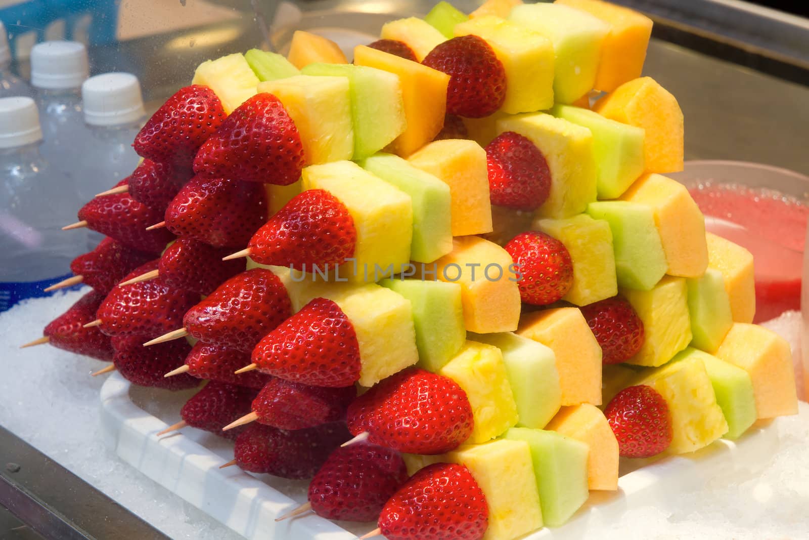 Cut Fruits on Sticks with Strawberries Pineapples Honeydews Cantelopes and Melons in Display Case