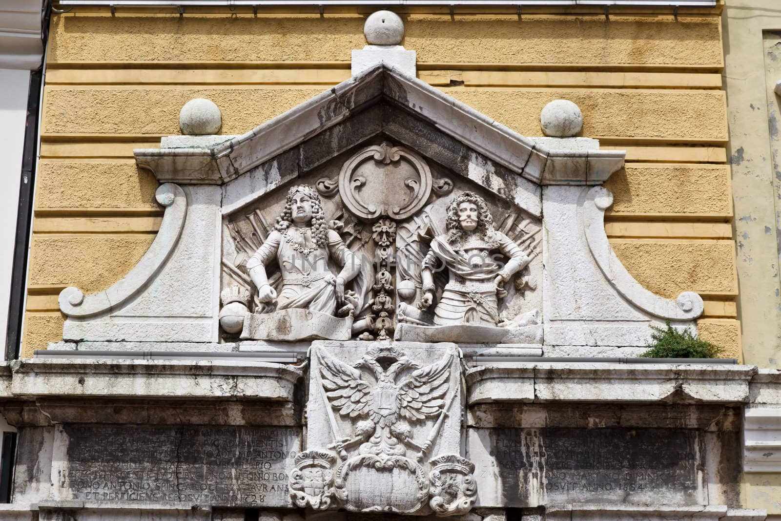 Relief with Two Men on Yellow Building in Rijeka, Croatia