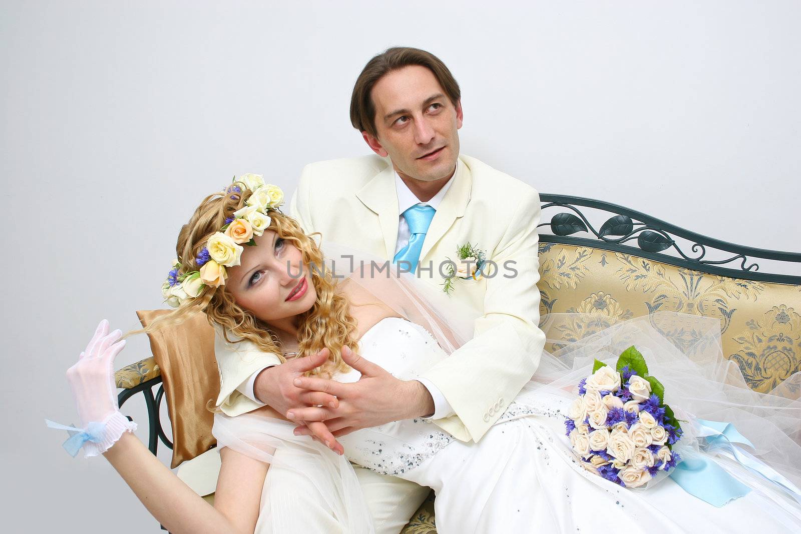 Young couple posing in a studio on the wedding day  by NickNick