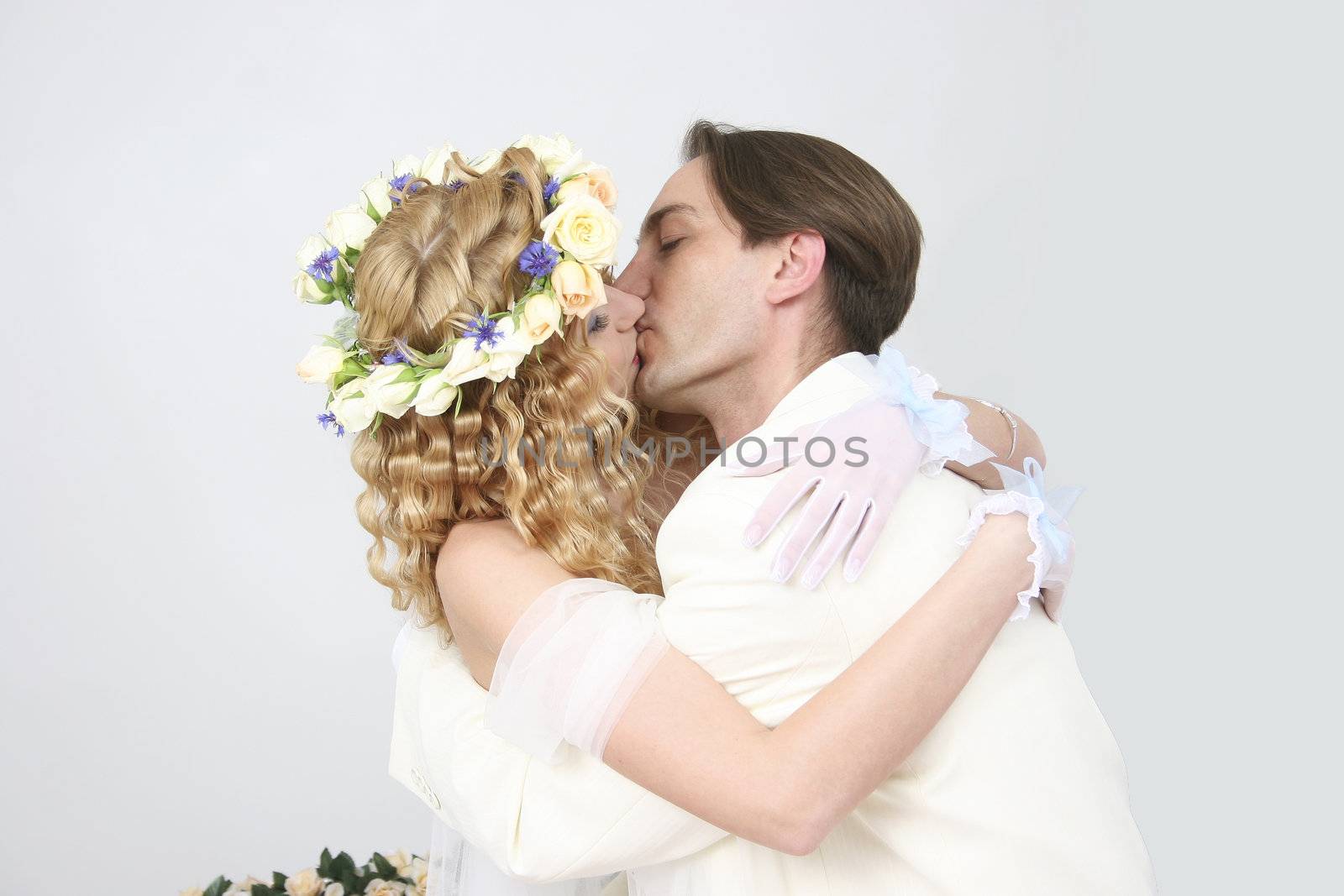Young couple posing in a studio on the wedding day by NickNick