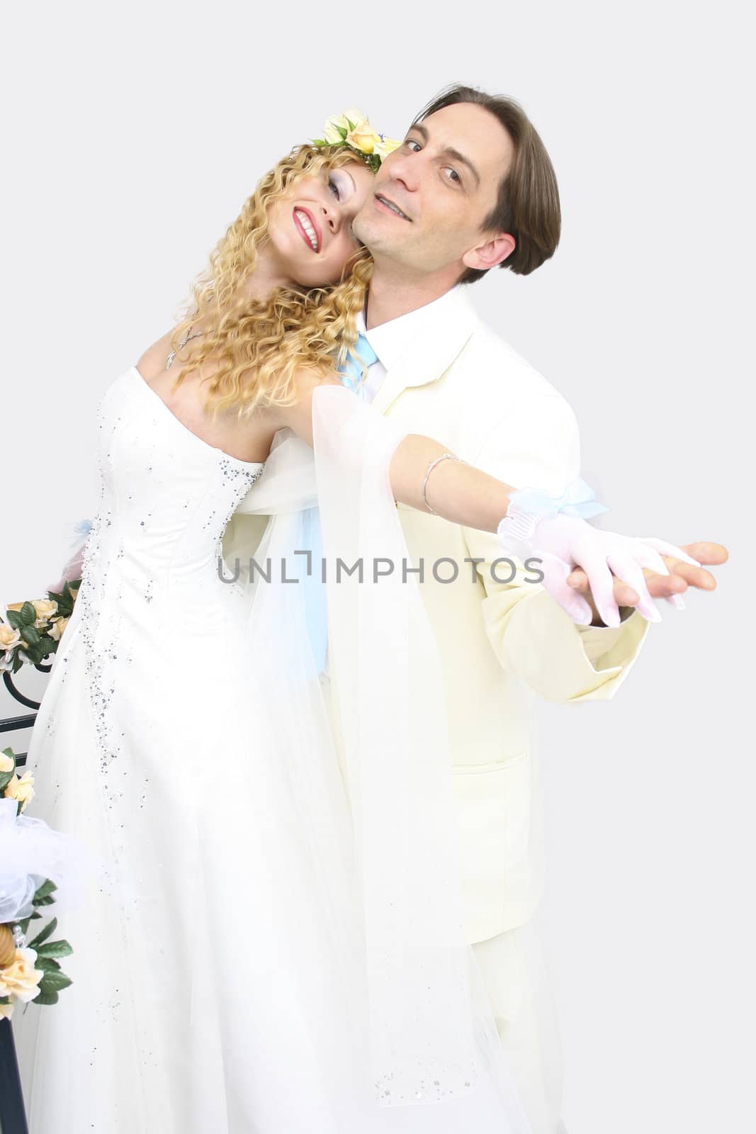 Young couple posing in a studio on the wedding day 