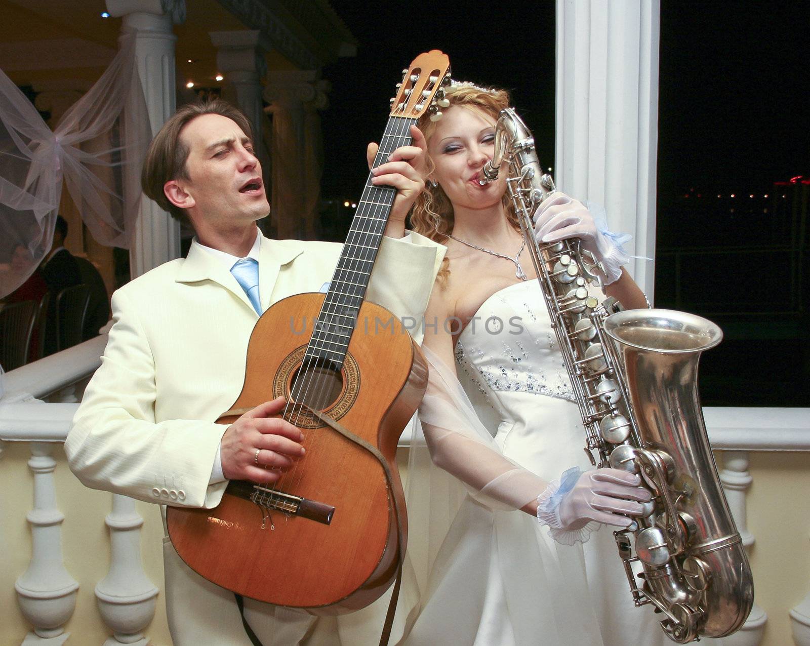 The bride and groom are entertained guests at a party in honor o by NickNick