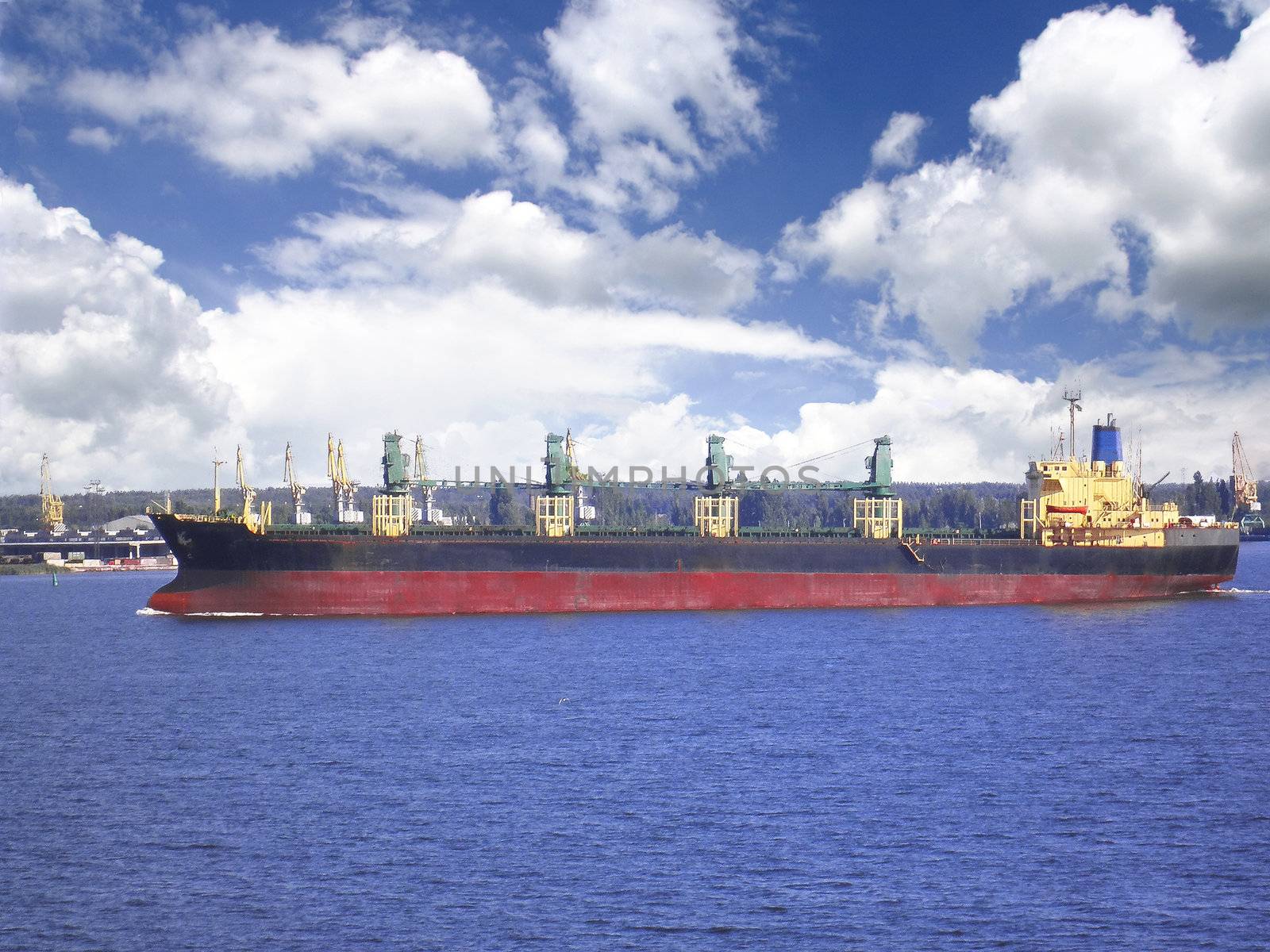 The passage of the cargo ship on a waterway