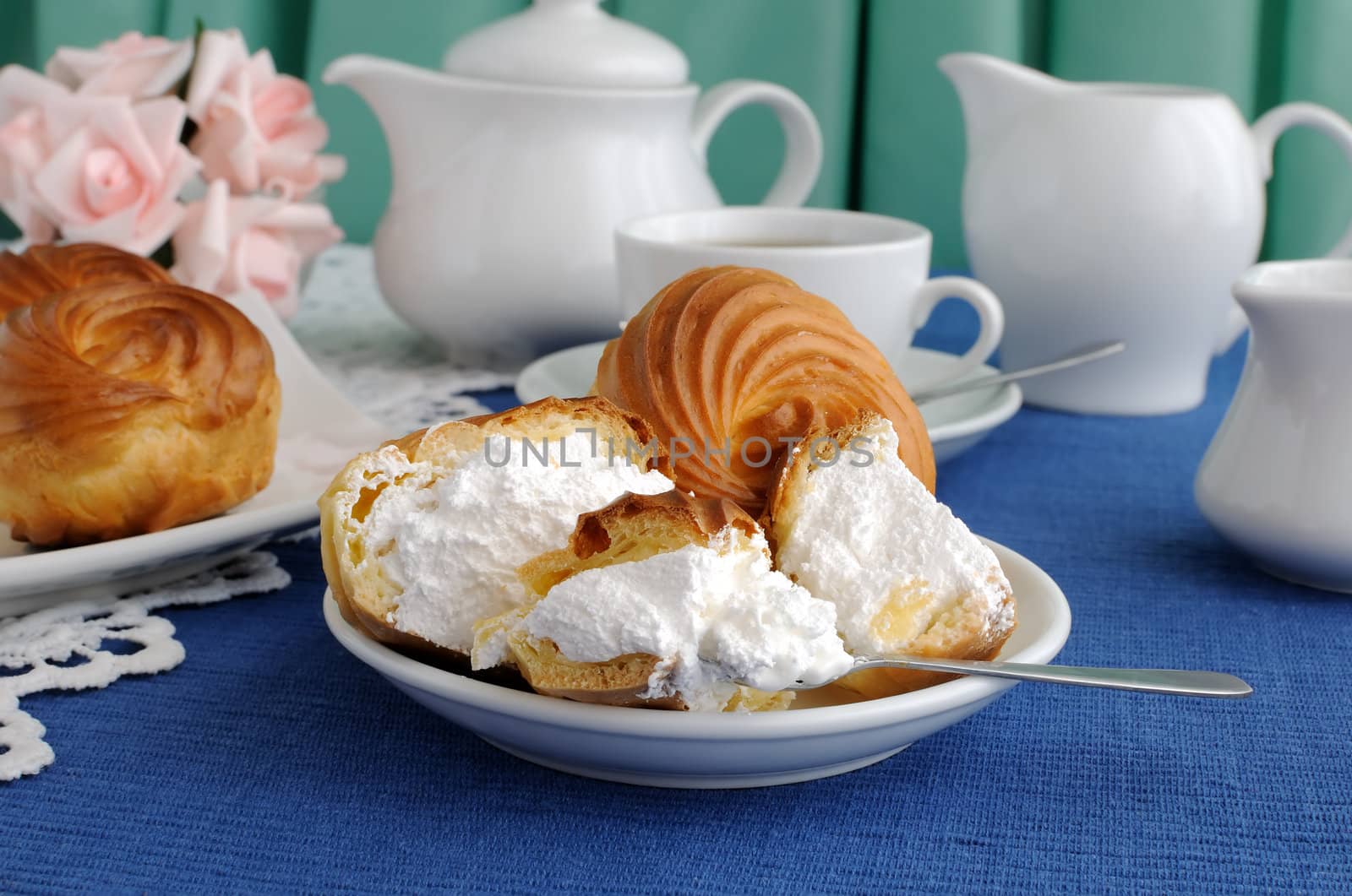 Eclairs with cottage cheese and protein fillings in the context of a close-up on a plate with a cup of coffee