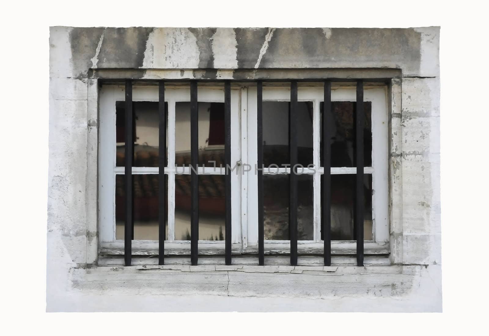 White little window isolated with black bars and dirty stone