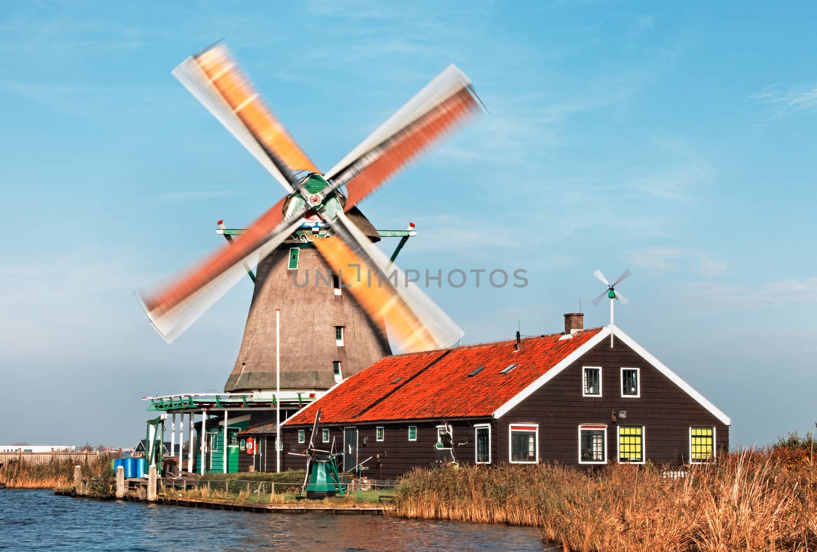 Image of a dutch windmill from Zaanse Schans, during a windy day with motion blur on the sails. 