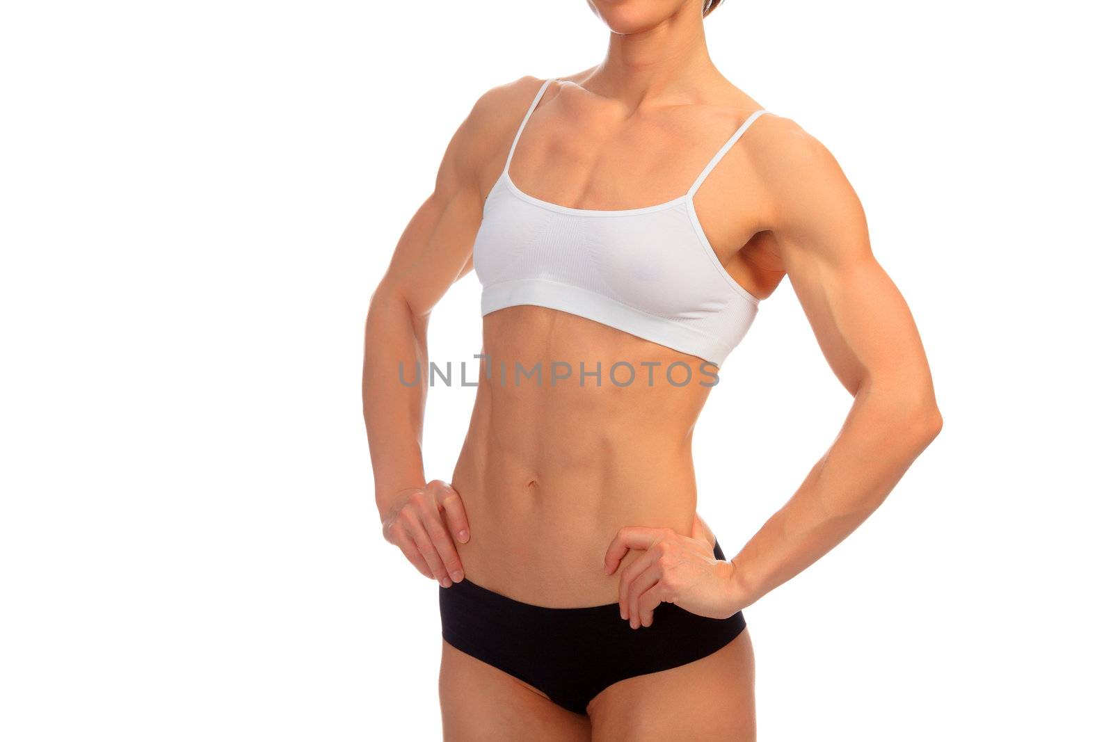 Tanned female bodybuilder posing against white background.