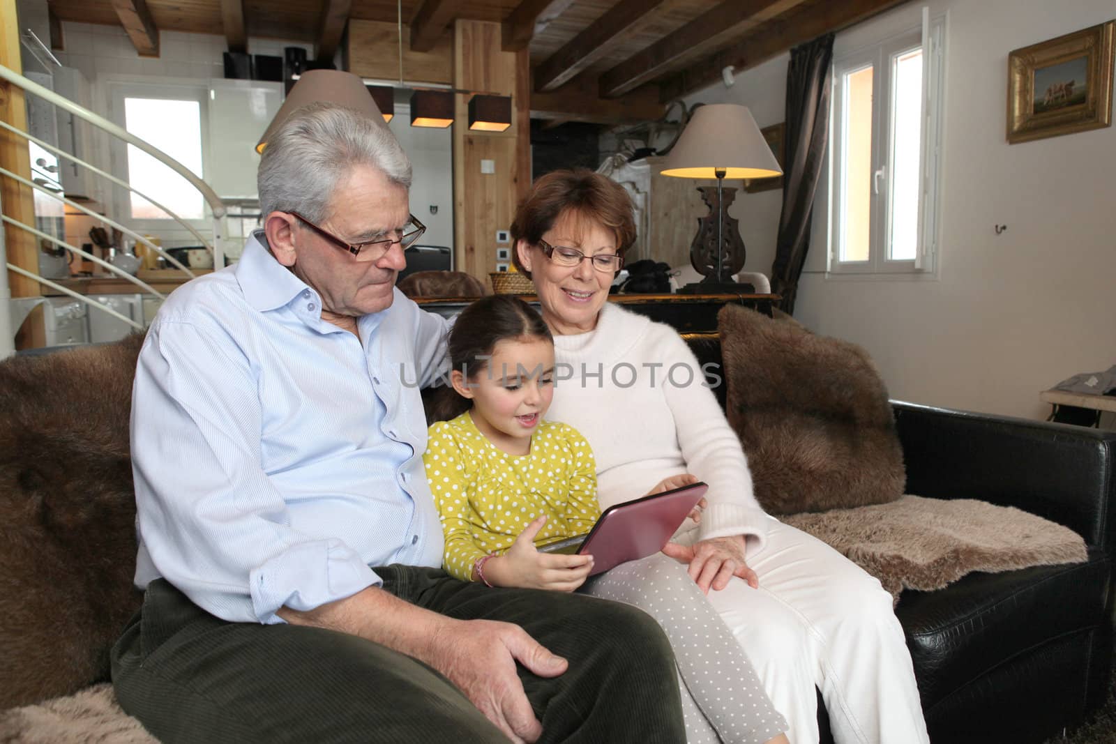 Old couple sat with their granddaughter