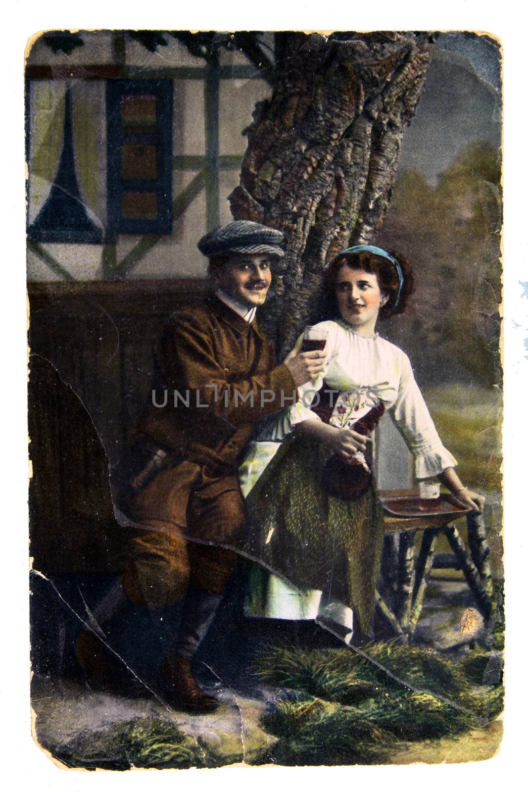 RUSSIA - CIRCA 1911: Postcard printed in Russia shows man with a glass of wine standing next to a woman holding a jug - Russia 1911