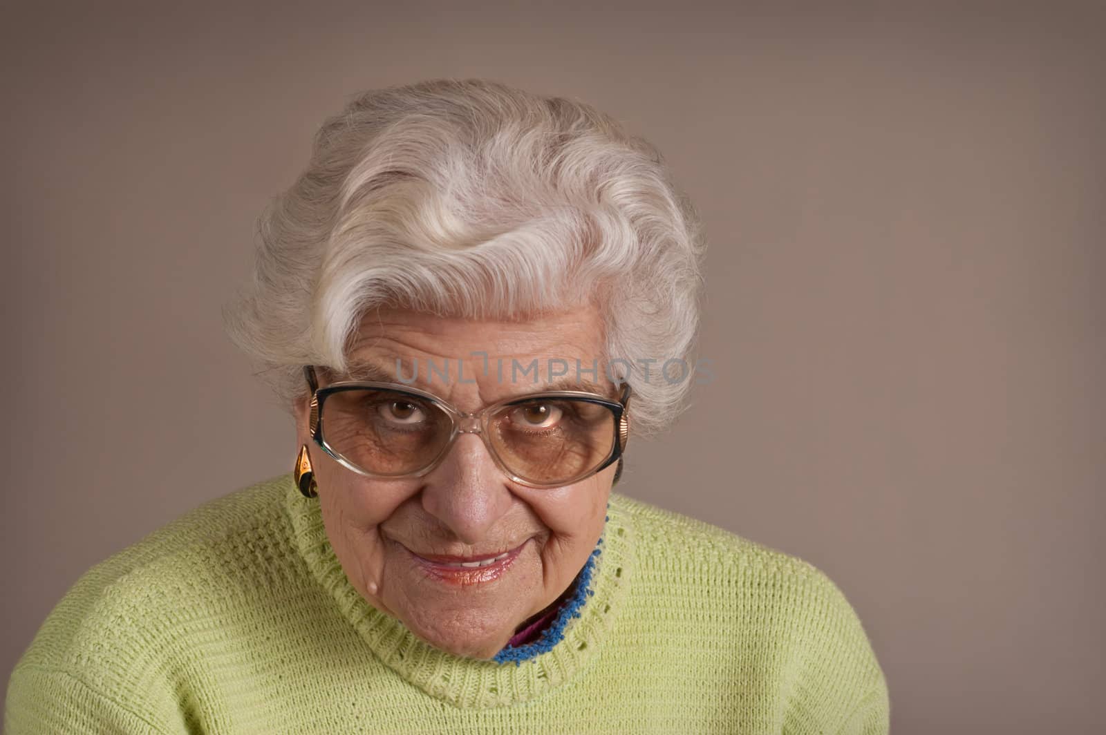 Senior lady portrait, smiling, glasses, with copy space. 