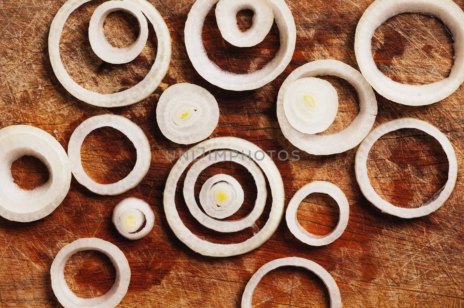 Onion rings on wooden cutting table