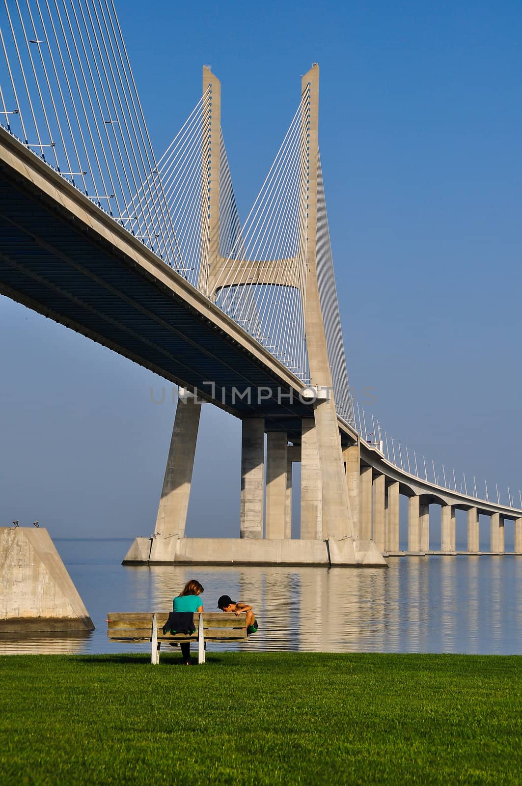 Mother and son relaxing under the bridge