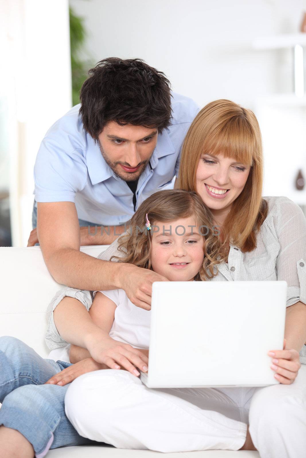 Family using a laptop by phovoir