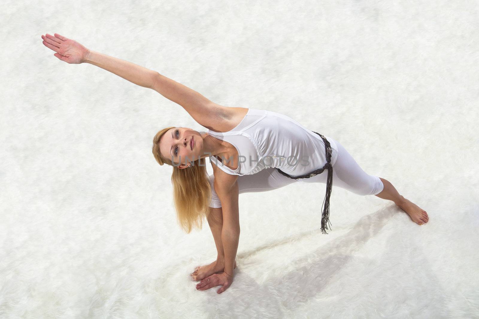 Young beautiful girl is professionally engaged in yoga  by NickNick