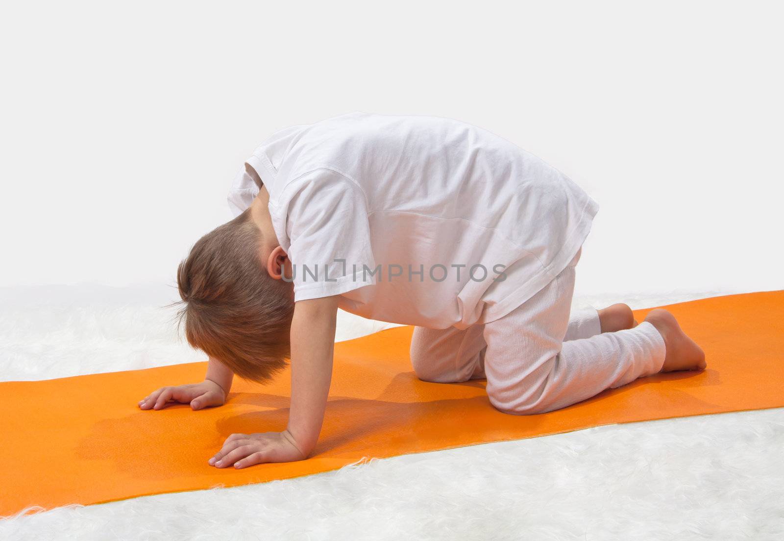 Children's yoga. The little boy does exercise. 