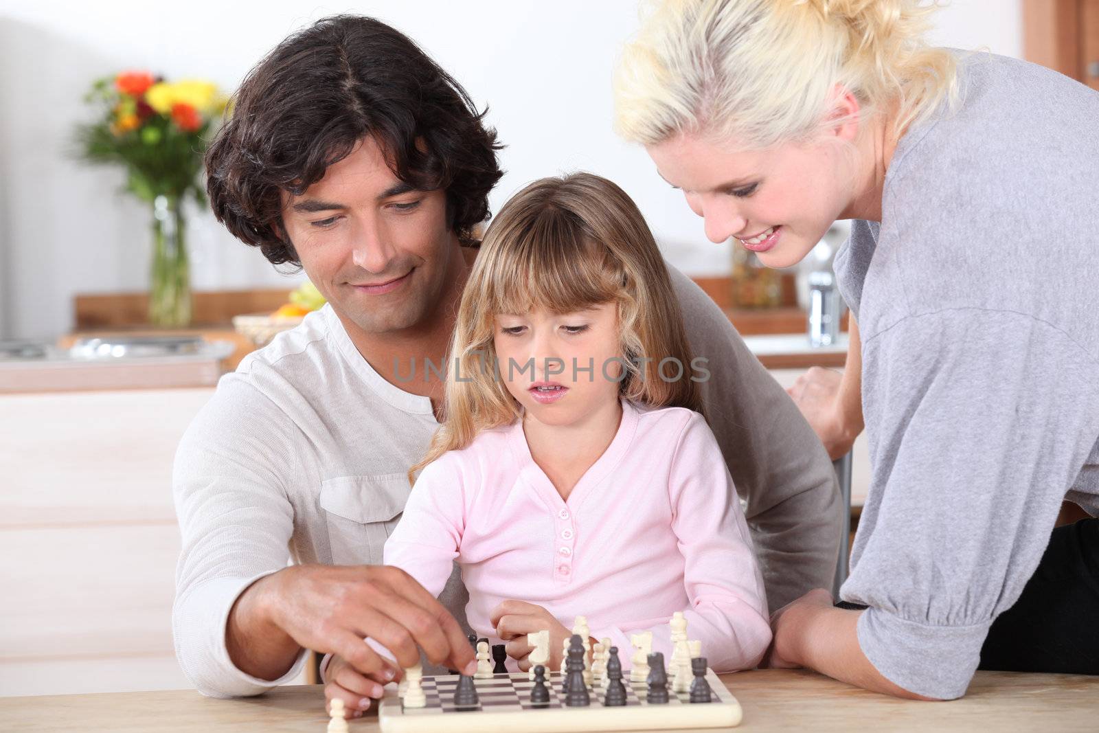 Young family playing chess