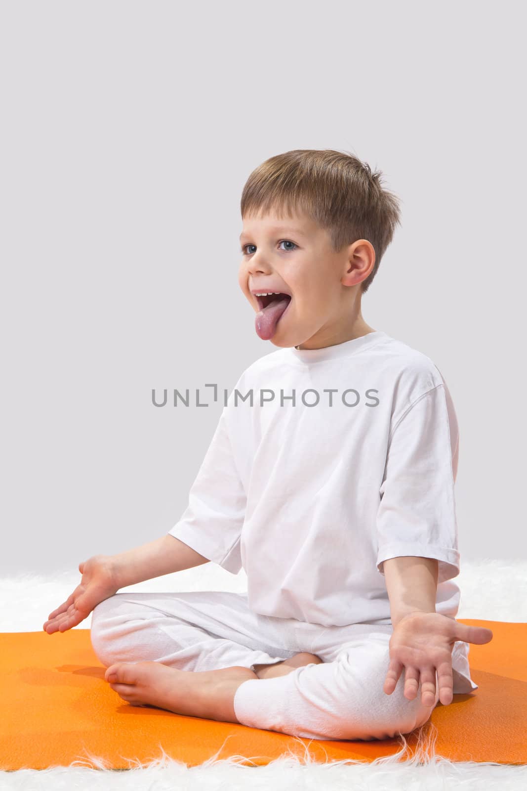 Children's yoga. The little boy does exercise. 