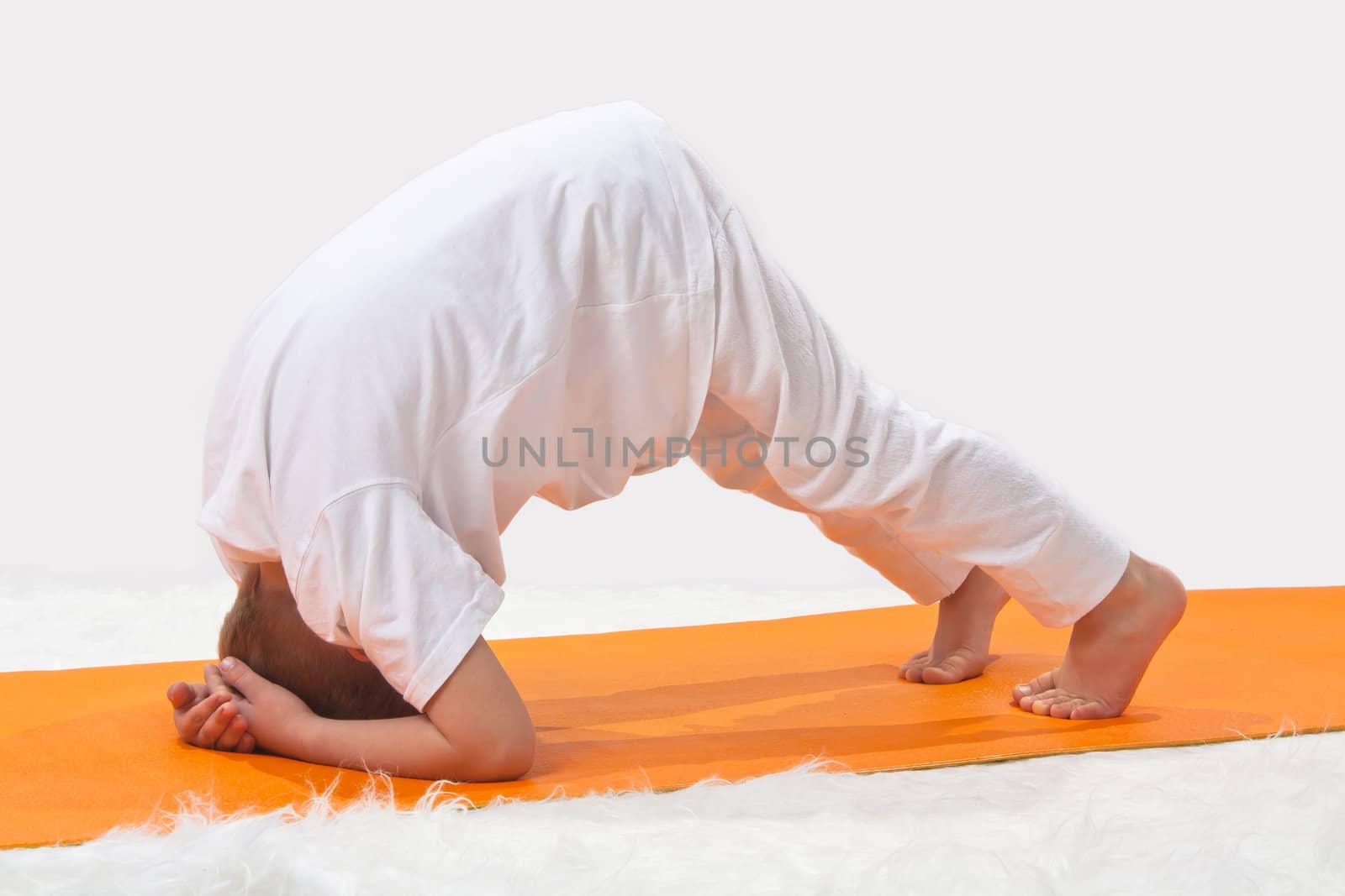 Children's yoga. The little boy does exercise. 