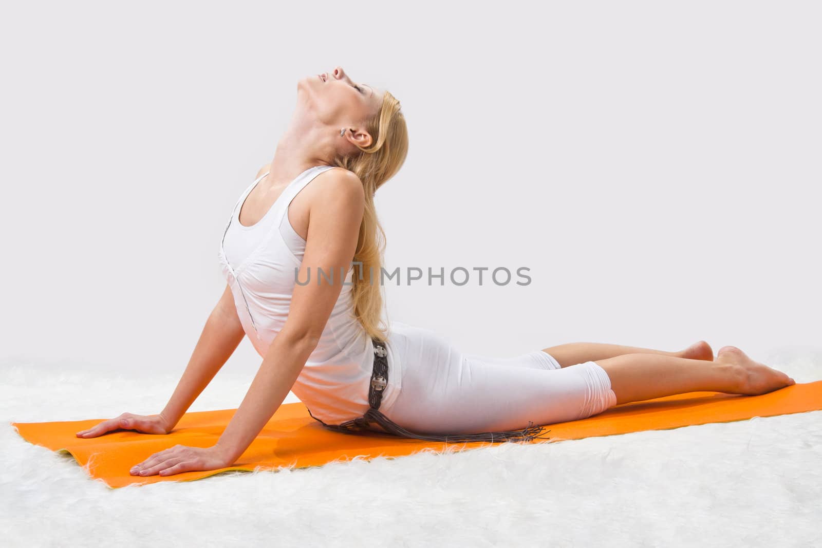 Young beautiful girl is professionally engaged in yoga 